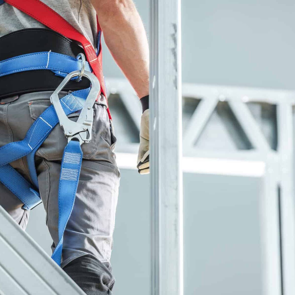 Construction Safety Harness Equipment. Industrial Security and Protection. Contractor at Height Closeup Photo.